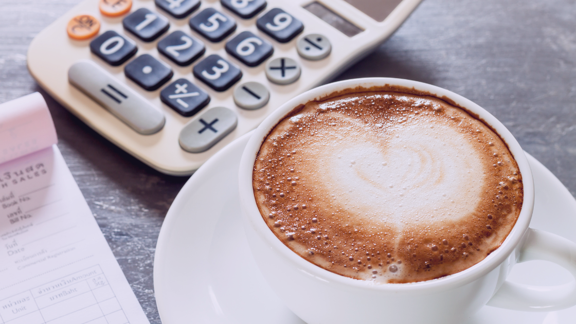 coffee calcu Cup of coffee with a receipt and calculator on a desk, symbolizing business expenses and VAT.